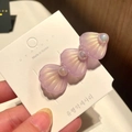 Detail view of light purple shell hair clips with glossy pearls on a white display card - 7* Large Shell - Purple