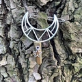 Macro detail of hollow moon hair clip with wire-wrapped crystal on natural tree bark background - Gold Crystal