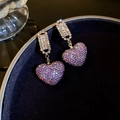 Macro shot of gold tassel earrings with purple heart crystals and sparkling cubic zirconia - Gold-Purple-Heart