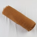 Macro detail of caramel crinkled cotton linen scarf showing soft fringe and fabric texture - Reddish Brown