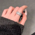 Elegant silver bow-shaped ring featuring sparkling moissanite stones on a finger - White Gold Ljz-244 / Adjustable Open
