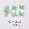 Macro detail of mint opal butterfly nail charms with silver frame and mini rhinestones - Hollow Cat Eye Butterfly Silver Frame Style (9823)