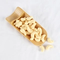 Artificial PVC cashew nut prop in wooden scoop showing realistic creamy texture - Raw Cashews (500g)