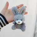 Close-up of grey curly plush bunny keychain with dark plaid bow and gold metal clasp - Gray / Lobster Clasp Keychain