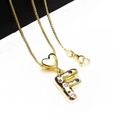 Detailed shot of golden letter F pendant with colorful cubic zirconia and heart clasp - Pendant with Necklace / Letter F