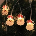 Festive Santa Claus LED string lights hanging on a Christmas tree with warm yellow glow - Santa Claus (Injection)