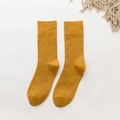 Vertical flat lay of mustard yellow ribbed knit crew socks with a vintage cotton texture - One Size / Turmeric