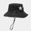 Detail of black washed denim bucket hat featuring white star patch and adjustable chin strap - One Size / Black