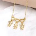 Gold necklace with three hollow hearts and pendants featuring one boy and two girls - 2 Girls 1 Boy / Gold