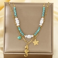 Detail of gold starfish and seahorse pendants with baroque pearls on layered necklace - Turquoise Seahorse Starfish Style (KN292176-SXSJ)