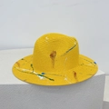 Detailed view of handmade graffiti painting on a bright yellow woven straw sun hat - M / Yellow (Graffiti Splatter)