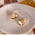 Elegant champagne gold curved pearl earrings with large pink pearls on a ceramic dish - Gold Twisted Circle (25# Silver Earring Post)