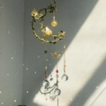 Handmade moon crystal wind chime with green leaf rope and pink stone butterfly accents - Sunstone