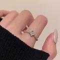 Micro-set zircon butterfly ring with twisted silver band and heart detail worn by a model - Butterfly Ring (Single)