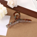 Detailed close-up of a brown and blue striped acetate hair claw clip with floral accents - 13cm / Blue Amber/Blue Brown Mixed