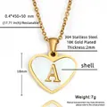 Macro shot of 18K gold plated heart pendant with letter A and white shell inlay detail - Letter A - Gold Heart White Shell