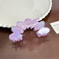 Purple acetate heart-shaped hair claw clip with a pearlescent finish on dark wood - Iridescent Purple Petal Claw