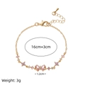 Golden butterfly bracelet with pink zircon heart accents and dimension specifications - Gold Butterfly Flower Bracelet