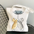 Kawaii cat printed white canvas tote bag with two cats under a blue umbrella - Two Cats with Blue Umbrella
