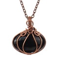 Close-up of handmade wire wrapped black gemstone pumpkin pendant on bronze necklace chain - Black (Obsidian)