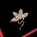 Macro shot of a flower brooch with marquise-cut clear stones and gold-tone stem - Transparent Gem Floral Style (B754)