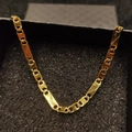 Detailed close-up of 18K gold-plated stainless steel flat link chain in a jewelry box - Necklace 4