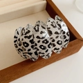 Detail of leopard print acrylic bracelet on brown velvet jewelry gift box - White