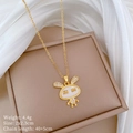 Close-up of golden bunny pendant with white enamel inlay and sparkling crystals - A428 Titanium Steel Chain Copper Pendant