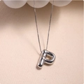 Macro shot of silver puffy letter P pendant on a delicate box chain with glossy finish - Silver (With Necklace) P