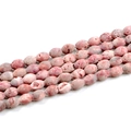 Macro detail of natural agate geode beads in pink with unique oval druzy textures - Red