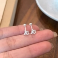 Silver twisted knot stud earrings with secure screw back closure shown in hand - Silver Knot Style (A335)