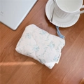Close-up of a floral quilted cotton mini pouch with zipper and light blue lanyard - Light Blue Floral Quilted