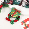Detailed view of festive Christmas scrunchie with green gift plush and bell ornaments - Woven Christmas Gift Box Hair Tie With Bell