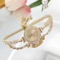 Detail of gold quartz bracelet watch featuring a crystal bezel and adjustable sliding clasp - Gold Case Gold Dial