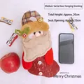 Calza natalizia in iuta con Babbo Natale, campanelli e dettagli in maglia, 20x13cm - Babbo Natale da appendere alla porta