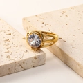 Detail of 18K gold-plated ring featuring a large clear zircon set on a textured stone - Gold White Zirconia