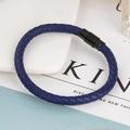 Navy blue braided leather bracelet with black magnetic clasp on a modern minimal desk - Blue Leather Black Buckle