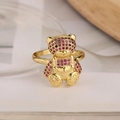 Macro detail of 18K gold plated bear ring featuring micro-paved pink and red zircons - Adjustable Open / Gold/Pink Zirconia