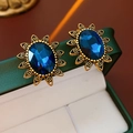 Close-up of vintage gold tassel earrings with oval blue sapphire gems in a jewelry box - Retro Oval Blue Gem Openwork Studs (34#)