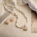 Detailed close-up of heart pearl necklace and earrings on premium silk and vintage paper - Gold Pearl Heart Set