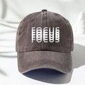 Detail view of washed cotton baseball cap with artistic FOCUS print and vintage texture - One Size / Coffee