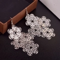 Silver hollow filigree floral long drop earrings hanging on a brown jewelry box - H1541 Hollow Filigree Effect