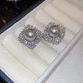 Macro shot of gray pearl earrings with zircon petals in an ivory jewelry display box - Silver Grey Pearl Square Petal Stud Earrings