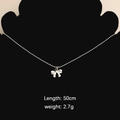 Silver bow pendant necklace in stainless steel on black display with 50cm length info - Bow 3 Necklace (Steel Color)