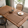 Set of 4 brown woven cotton linen placemats with fringe tassels on a wooden table - Khaki Pattern