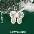 Detail of cream lace bow patch showing dimensions 4cm x 4.3cm on dark green background - Off-white Lace Bow Style (08)