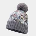 Detailed view of colorful sequins on knitted hat with a fluffy grey faux fur pompom top - Gray
