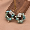 Vintage pearl and turquoise drop earrings with gold wire wrap on a wood display - Turquoise Pearl Drop Earrings
