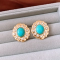 Dettaglio di orecchini vintage a fiore in oro con pietra turchese e strass scintillanti - Orecchini (Perno S925-Oro-Blu)