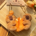 Cute capybara plush keychain set with orange bread accessory on a bamboo tray - Bread Duo